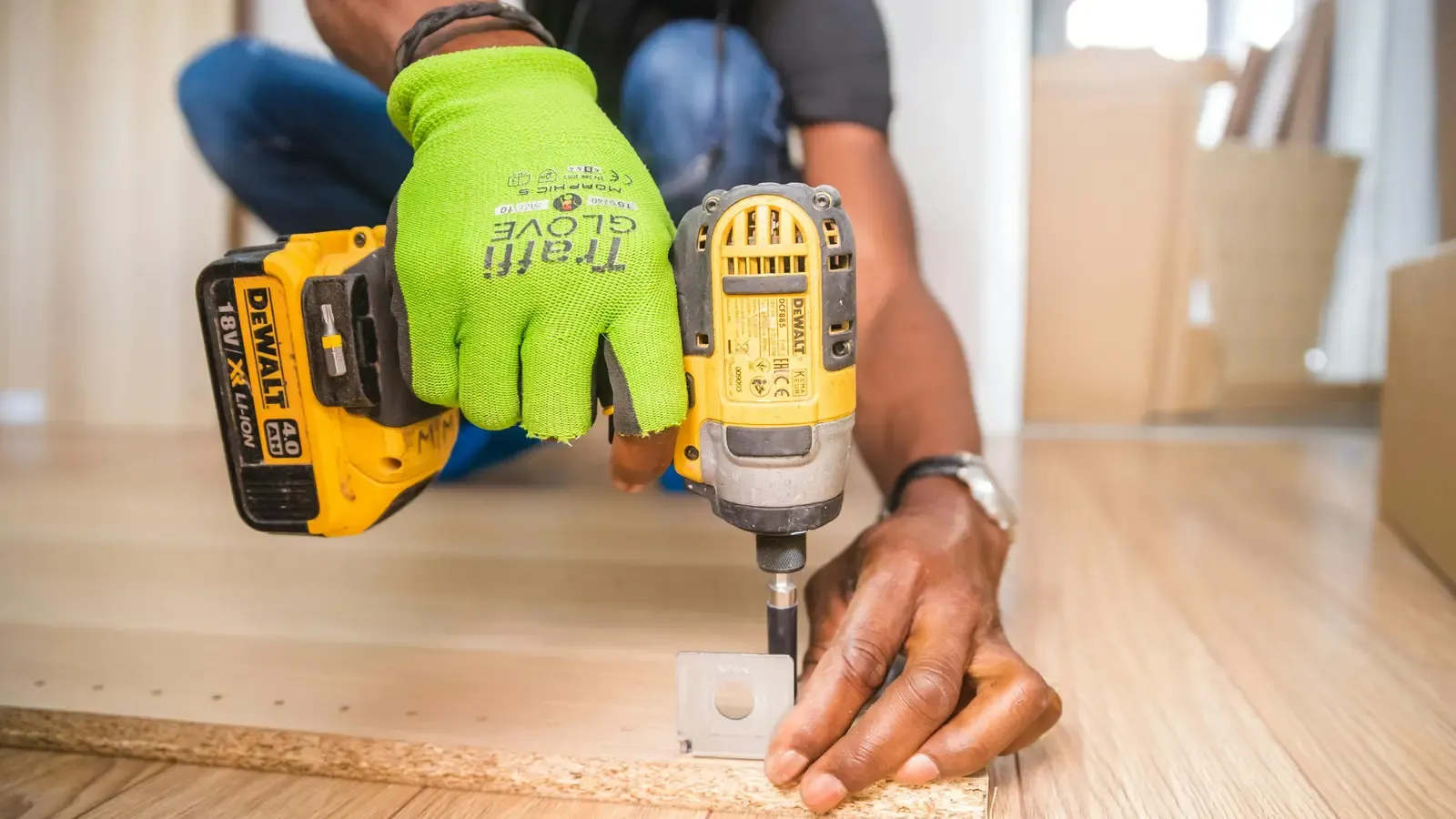 Field technician using a power drill during an on-site service call